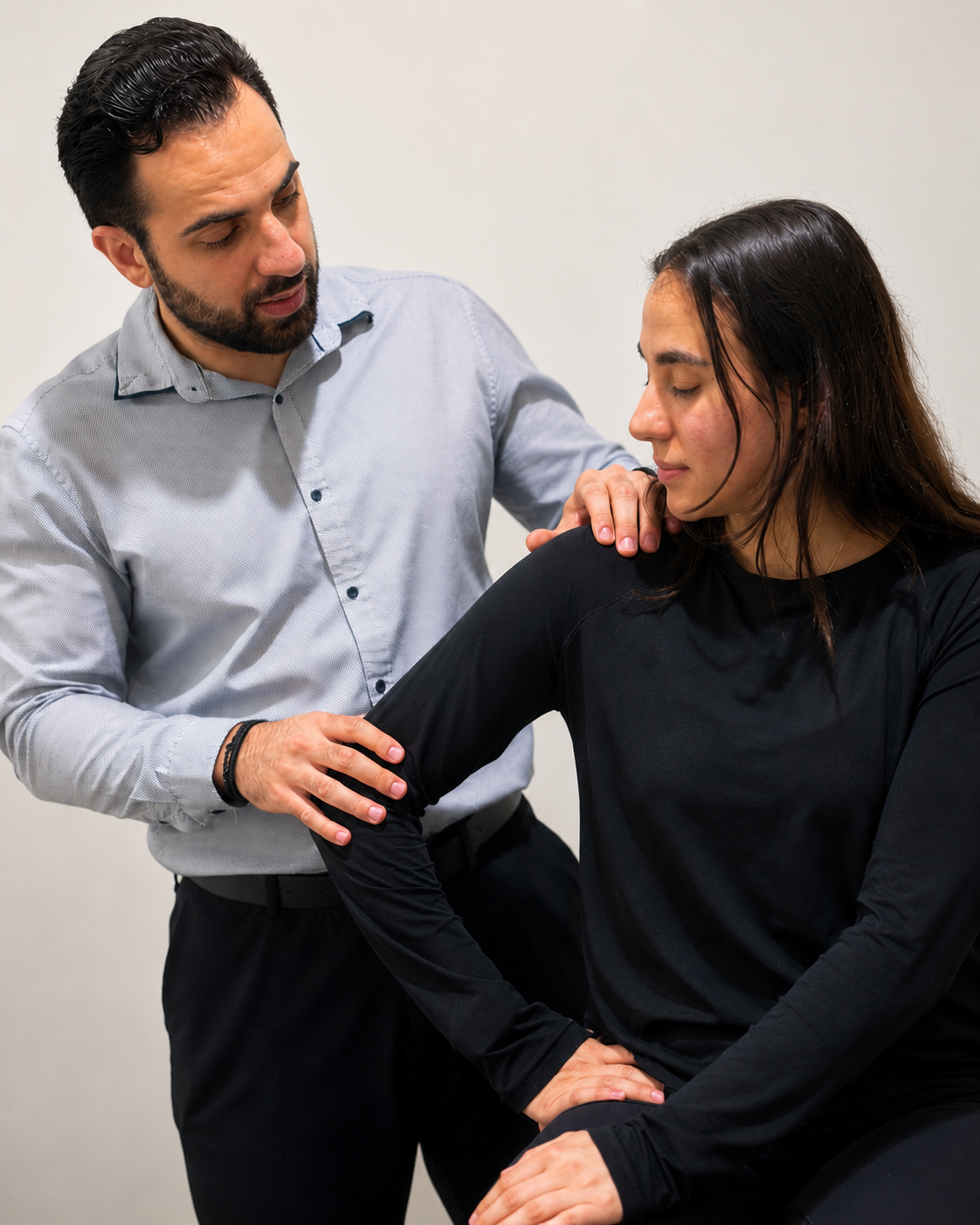 Physiotherapist assessing a patient's shoulder
